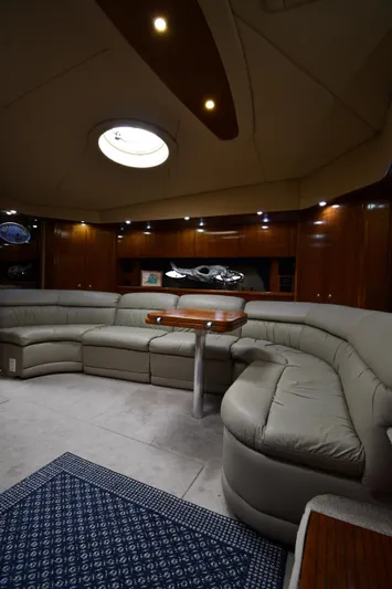 This Is It Yacht Photos Pics Luxurious interior of 2005 Cruisers Yachts 520 Express with plush seating and elegant wood finishes.