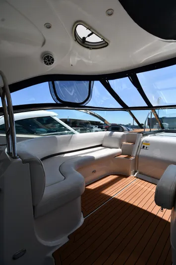 This Is It Yacht Photos Pics Interior of a 2005 Cruisers Yachts 520 Express with white seating and wooden flooring.
