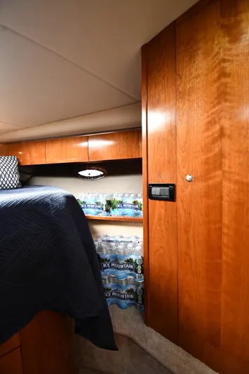 This Is It Yacht Photos Pics Interior cabin of a 2005 Cruisers Yachts 520 Express with wooden cabinetry.