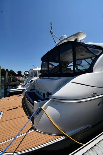This Is It Yacht Photos Pics 2005 Cruisers Yachts 520 Express docked at a marina on a sunny day.