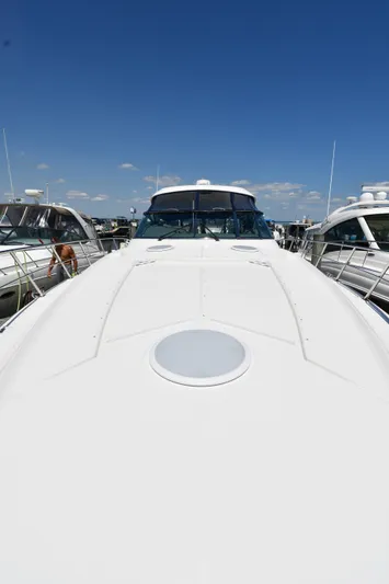 This Is It Yacht Photos Pics 2005 Cruisers Yachts 520 Express docked under a clear blue sky.