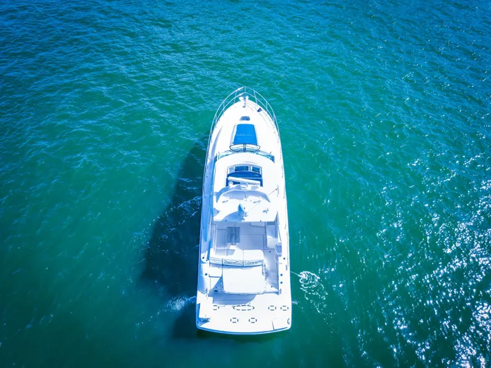  Yacht Photos Pics Aerial view of a 2010 Sea Ray 450 Sundancer yacht on blue water.