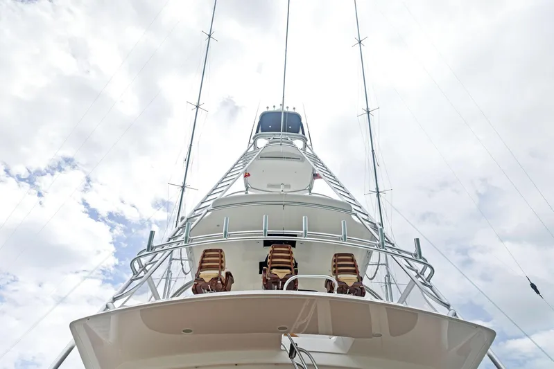 Mvp Yacht Photos Pics 2018 Viking 80 Convertible yacht with tower and outriggers against a cloudy sky.
