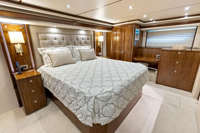 Mvp Yacht Photos Pics Luxurious bedroom interior of 2018 Viking 80 Convertible yacht with elegant decor.