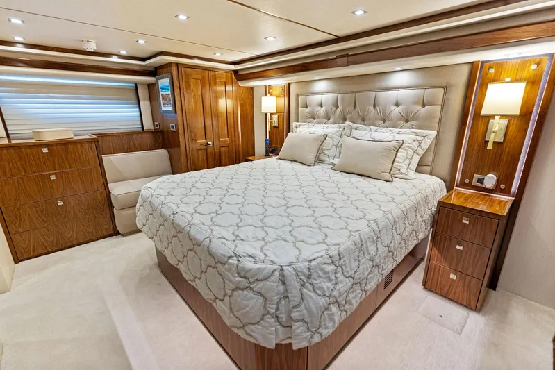 Mvp Yacht Photos Pics Luxurious bedroom interior of 2018 Viking 80 Convertible yacht with elegant wood finishes.