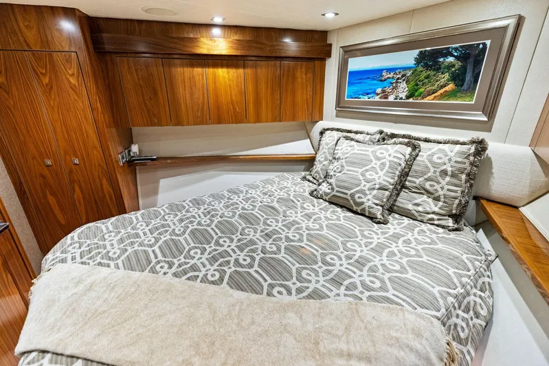 Mvp Yacht Photos Pics Luxurious bedroom interior of 2018 Viking 80 Convertible yacht with wooden cabinets.