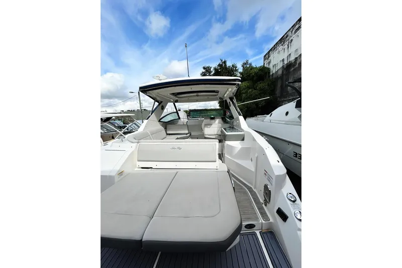  Yacht Photos Pics 2020 Sea Ray Sundancer 320 yacht with spacious deck and seating, docked under blue sky.