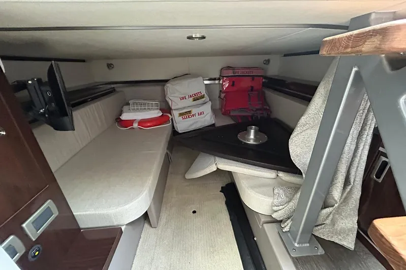  Yacht Photos Pics 2020 Sea Ray Sundancer 320 cabin interior with seating, life jackets, and safety equipment.
