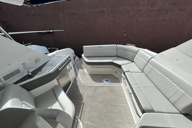 Yacht Photos Pics 2020 Sea Ray Sundancer 320 interior with spacious seating and kitchenette.