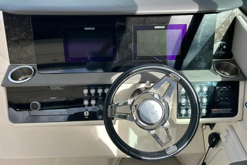  Yacht Photos Pics Dashboard of a 2020 Sea Ray Sundancer 320 with steering wheel and Simrad displays.