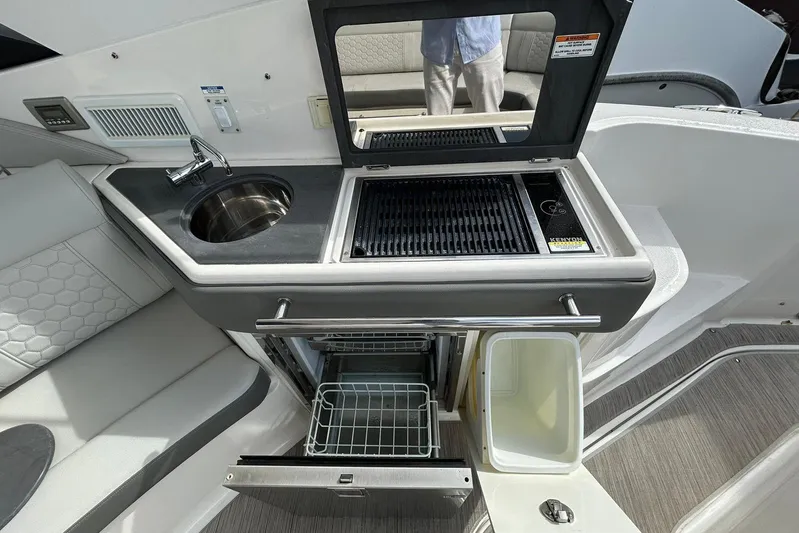  Yacht Photos Pics 2020 Sea Ray Sundancer 320 boat kitchen with sink, grill, and storage.