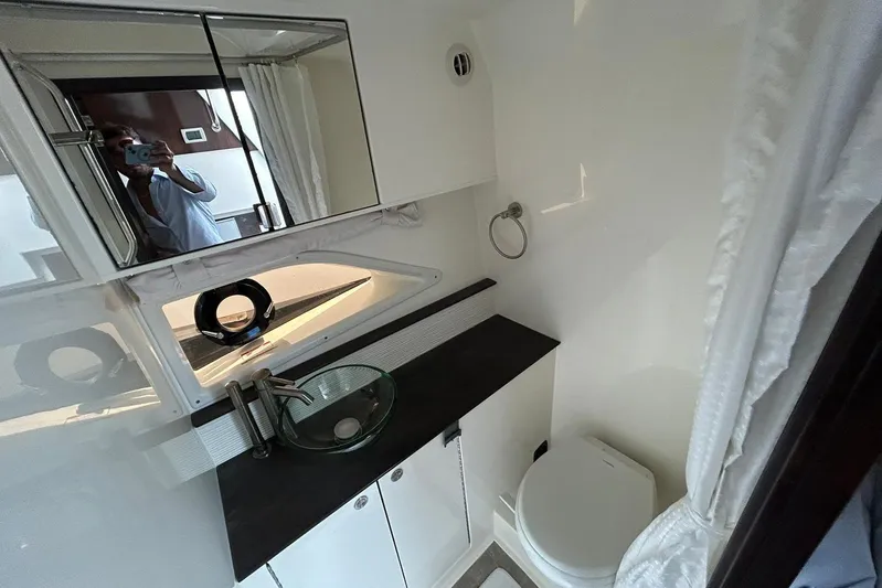  Yacht Photos Pics 2020 Sea Ray Sundancer 320 bathroom with modern sink, mirror, and toilet.