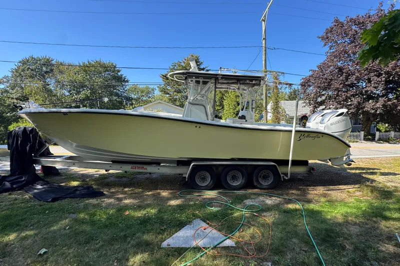  Yacht Photos Pics 2007 Yellowfin 34 Offshore boat on trailer, parked outdoors, with Suzuki engines.