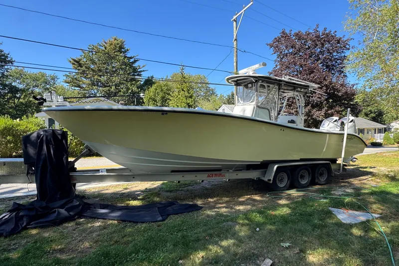  Yacht Photos Pics 2007 Yellowfin 34 Offshore boat on trailer, parked outdoors on a sunny day.
