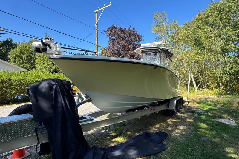  Yacht Photos Pics 2007 Yellowfin 34 Offshore boat on trailer, surrounded by trees and clear blue sky.