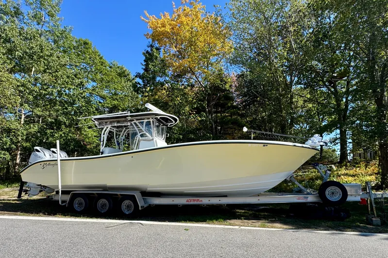  Yacht Photos Pics 2007 Yellowfin 34 Offshore boat on trailer, surrounded by trees.