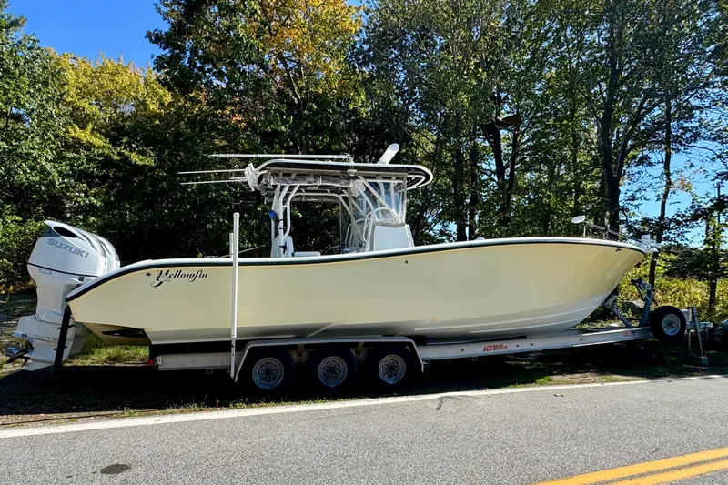  Yacht Photos Pics 2007 Yellowfin 34 Offshore boat on trailer, parked by a forested road.