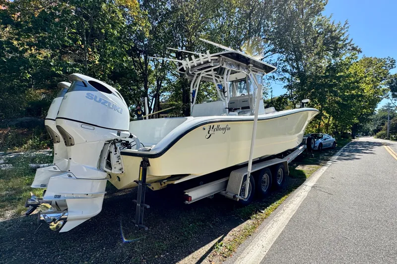  Yacht Photos Pics 2007 Yellowfin 34 Offshore boat on trailer with Suzuki engines, parked roadside.