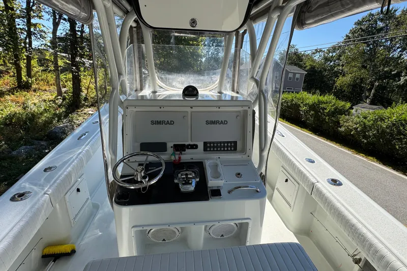  Yacht Photos Pics 2007 Yellowfin 34 Offshore boat cockpit with Simrad navigation system, steering wheel, and controls.