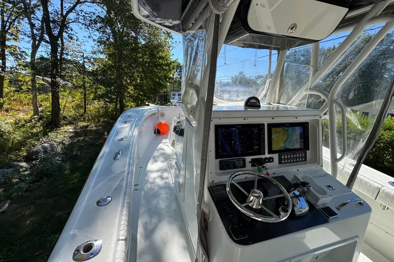  Yacht Photos Pics 2007 Yellowfin 34 Offshore boat cockpit with navigation controls and clear canopy.