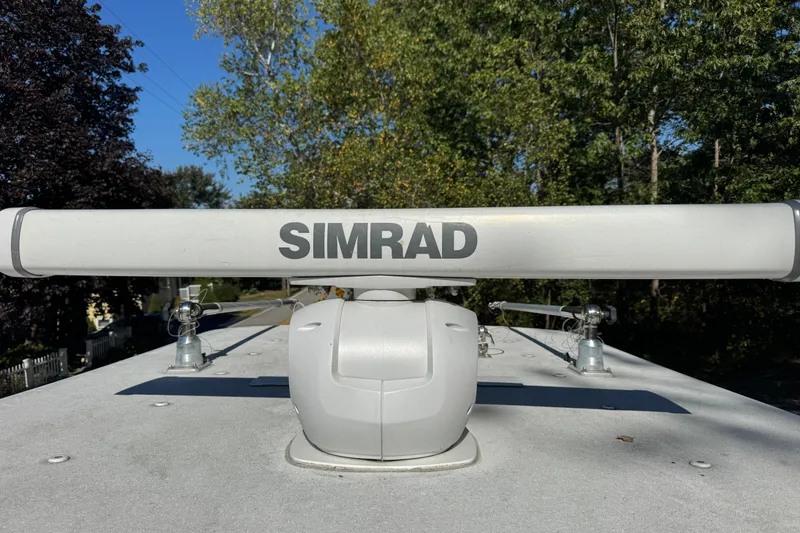  Yacht Photos Pics Simrad radar on 2007 Yellowfin 34 Offshore boat, surrounded by trees.