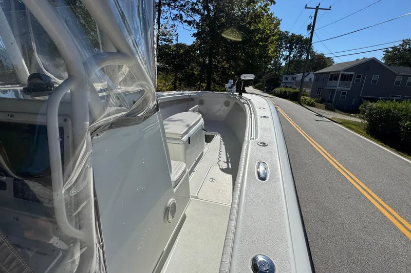  Yacht Photos Pics 2007 Yellowfin 34 Offshore boat on a road, showcasing deck and seating area.