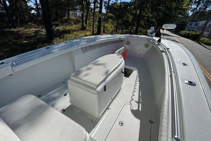  Yacht Photos Pics 2007 Yellowfin 34 Offshore boat interior with seating and storage, surrounded by trees.