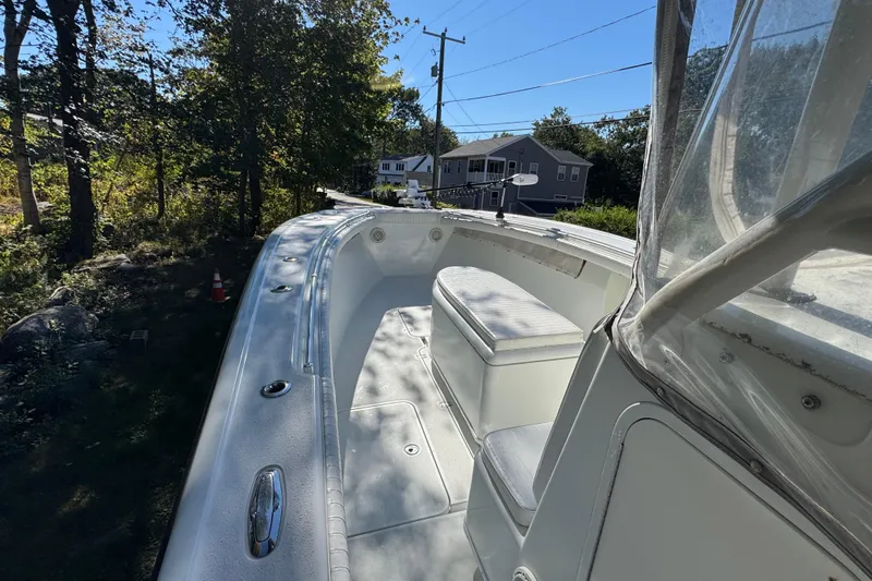  Yacht Photos Pics 2007 Yellowfin 34 Offshore boat deck with seating, surrounded by trees and houses.