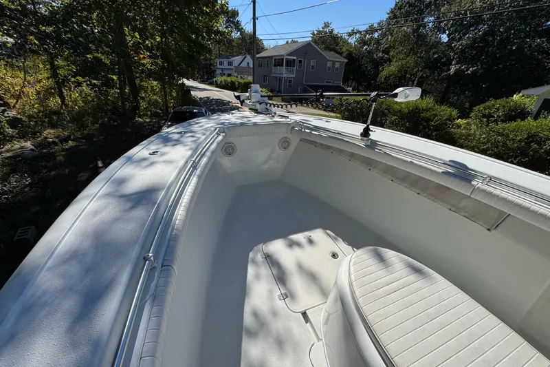  Yacht Photos Pics 2007 Yellowfin 34 Offshore boat deck with seating, surrounded by trees and houses.