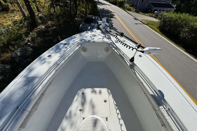  Yacht Photos Pics 2007 Yellowfin 34 Offshore boat on a road, surrounded by trees and a house.