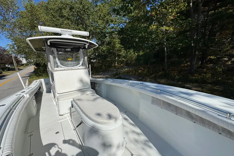  Yacht Photos Pics 2007 Yellowfin 34 Offshore boat with white seating, surrounded by trees.