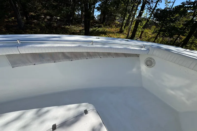  Yacht Photos Pics 2007 Yellowfin 34 Offshore boat interior with white seating and speaker, surrounded by trees.