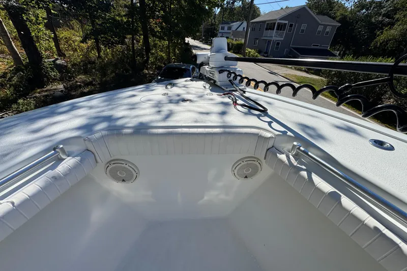  Yacht Photos Pics 2007 Yellowfin 34 Offshore boat deck with speakers and railing, surrounded by trees and houses.