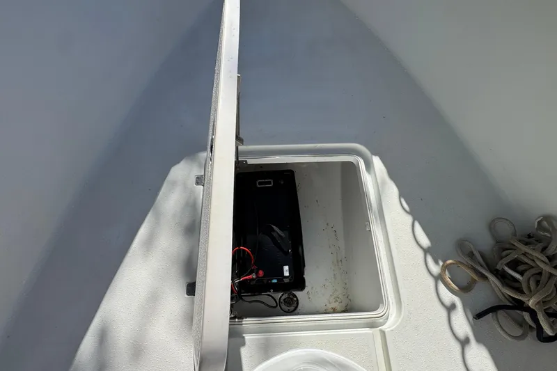  Yacht Photos Pics Open hatch on 2007 Yellowfin 34 Offshore boat, revealing storage compartment with battery and ropes.