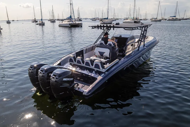  Yacht Photos Pics 2014 Midnight Express 37’ Open boat with triple Mercury engines on calm water.