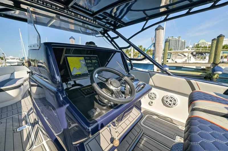 Opal Yacht Photos Pics 2014 Midnight Express 37’ Open boat interior with steering wheel and navigation display.