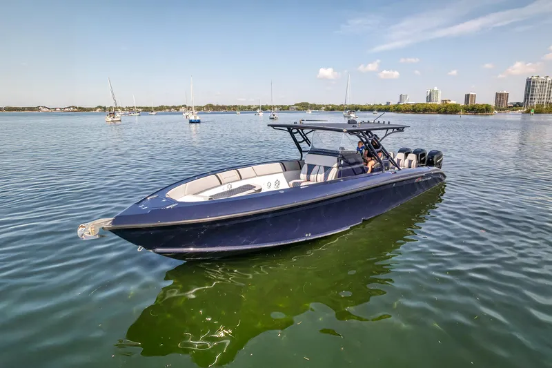  Yacht Photos Pics 2014 Midnight Express 37’ Open boat on calm water, cityscape in background.