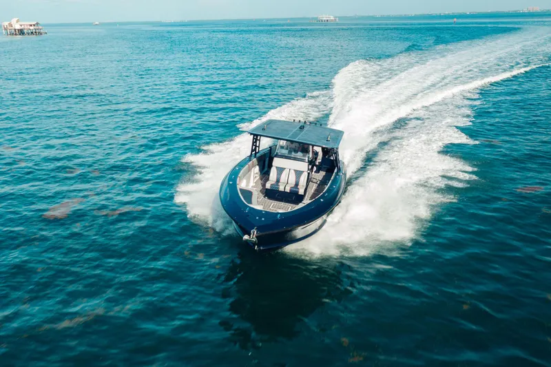 Opal Yacht Photos Pics 2014 Midnight Express 37’ Open boat cruising on clear blue water.