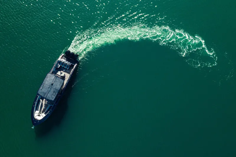 Opal Yacht Photos Pics Aerial view of 2014 Midnight Express 37’ Open boat cruising in clear green water.