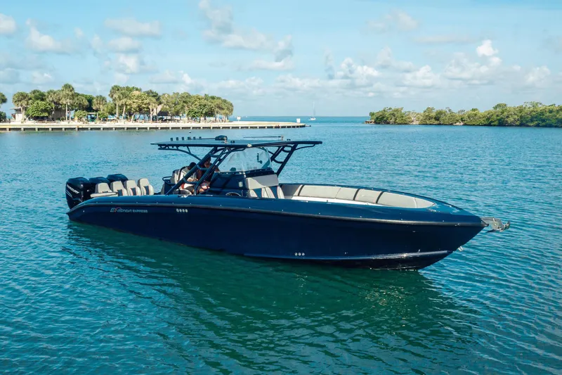 Opal Yacht Photos Pics 2014 Midnight Express 37’ Open boat on calm blue water, clear sky background.