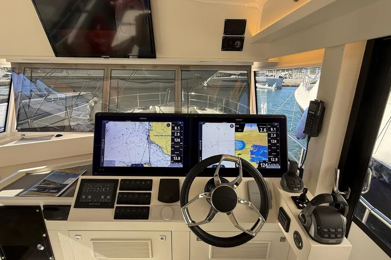 Kokkola Yacht Photos Pics Cockpit of 2023 Nord Star 49+ boat with navigation screens and steering wheel.