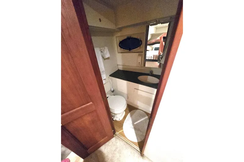  Yacht Photos Pics Bathroom interior of 2000 Silverton 392 Motor Yacht with sink and toilet.