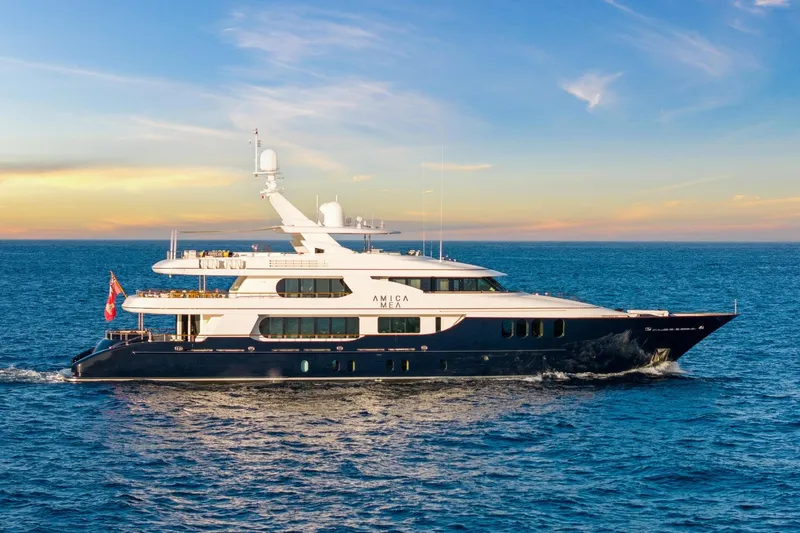 Amica Mea Yacht Photos Pics Luxurious 2004 Hakvoort Custom yacht cruising on open sea at sunset.