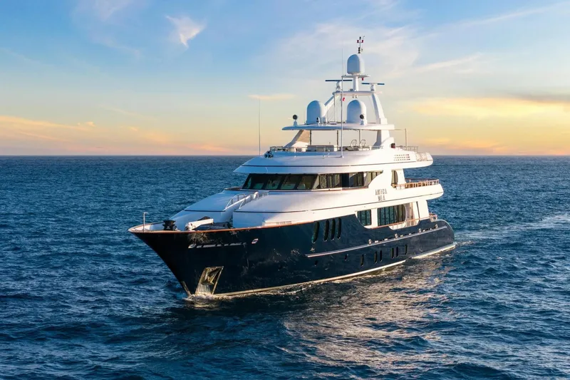 Amica Mea Yacht Photos Pics Luxurious 2004 Hakvoort Custom yacht cruising on open sea at sunset.