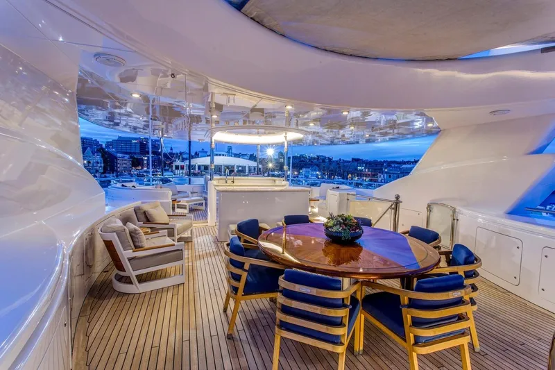 Amica Mea Yacht Photos Pics Luxurious 2004 Hakvoort Custom yacht deck with elegant seating and dining area at sunset.
