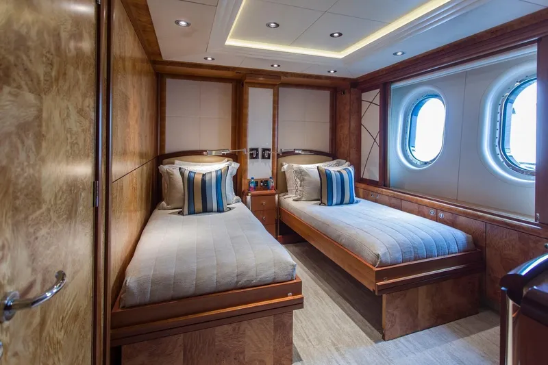 Amica Mea Yacht Photos Pics Luxurious twin cabin on 2004 Hakvoort Custom yacht with elegant wood finish and porthole windows.