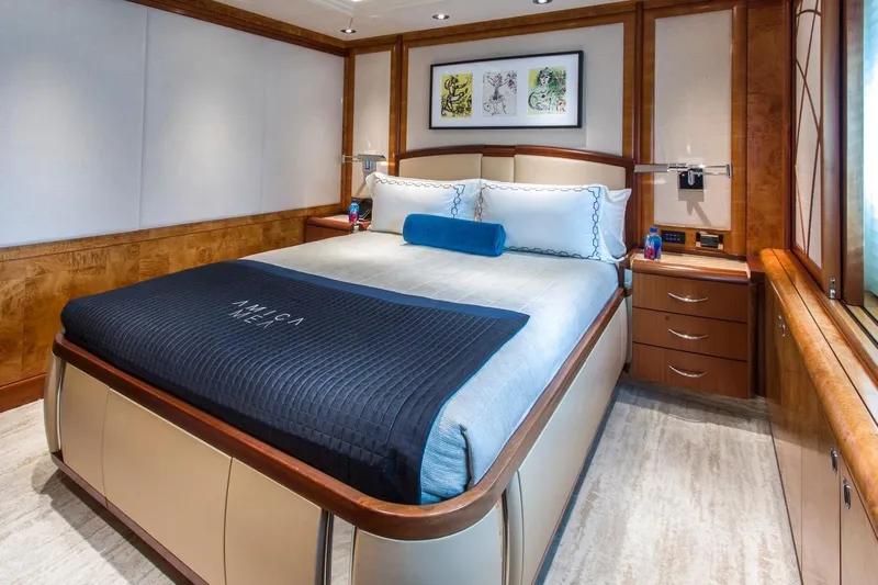 Amica Mea Yacht Photos Pics Luxurious bedroom interior on 2004 Hakvoort Custom yacht, featuring elegant wood finishes and modern decor.