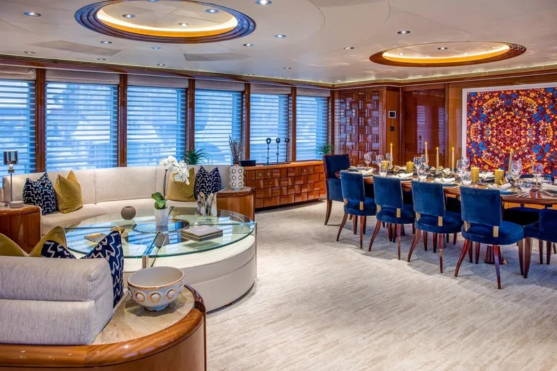 Amica Mea Yacht Photos Pics Luxurious yacht interior with elegant dining area, plush seating, and vibrant wall art. Hakvoort Custom 2004.