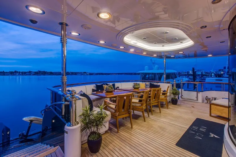 Amica Mea Yacht Photos Pics Luxurious 2004 Hakvoort Custom yacht deck with elegant dining area at sunset.