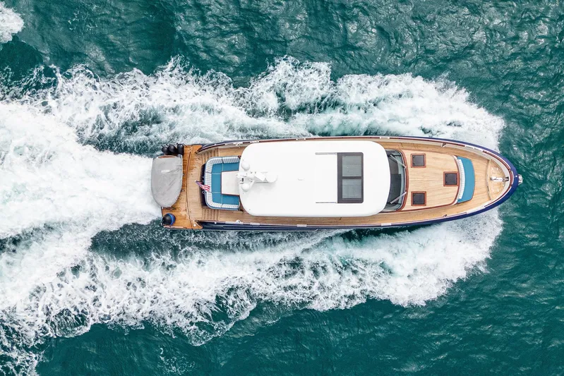 Tribu Yacht Photos Pics Aerial view of 2021 Steeler 60 S Performance yacht cruising on blue ocean waters.